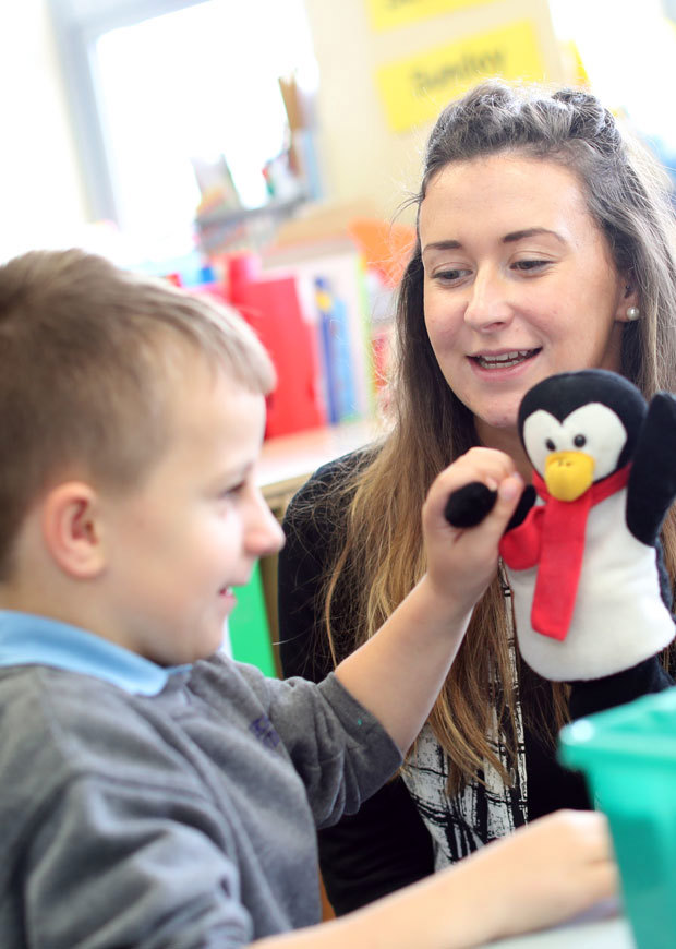 Close up of teacher working with child in class