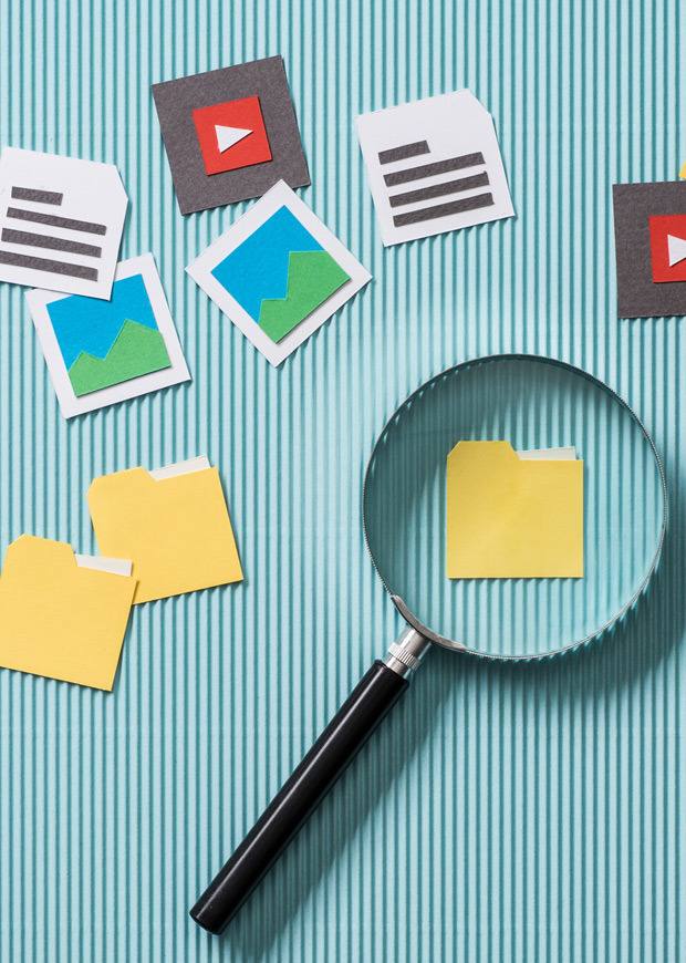 Magnifying glass locating a file folder in portrait layout