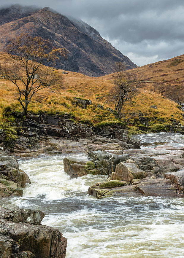Mouth of a river at the foot of mountains, portrait crop