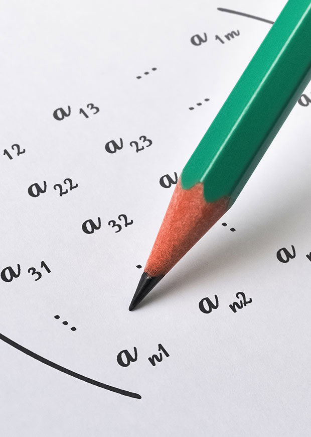 Close up of a pencil and a maths equation, portrait crop