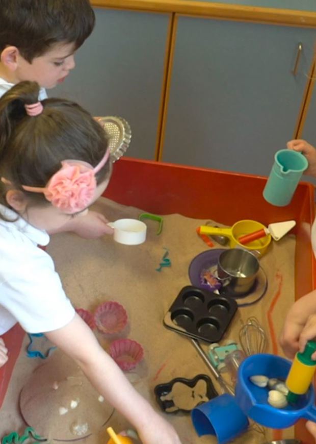 Children playing at a sandbox
