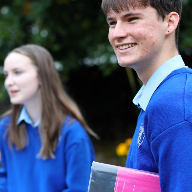 A happy student holding a textbook