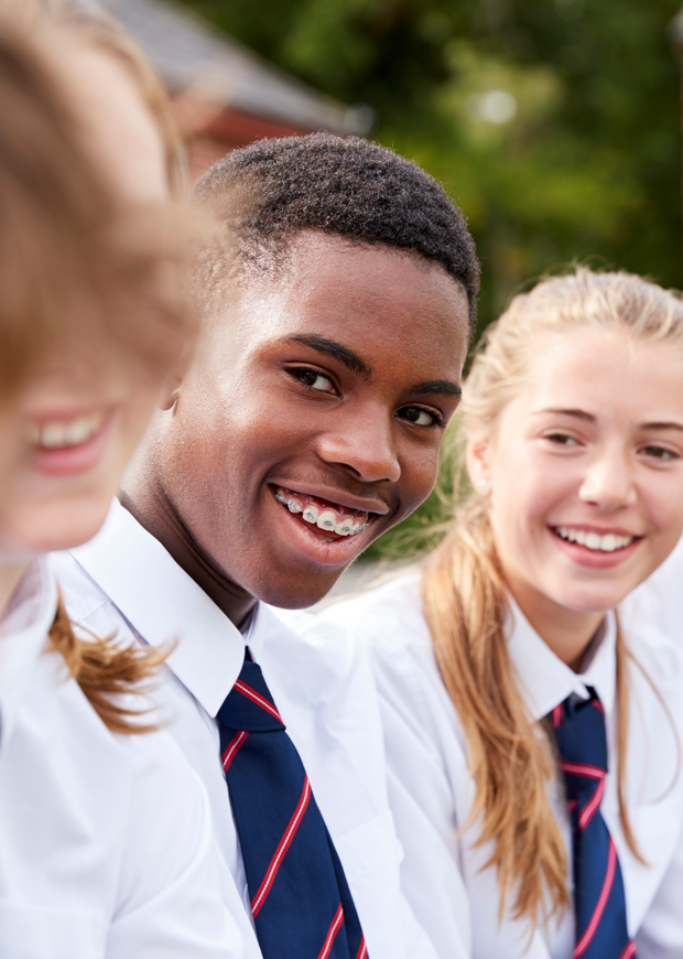 Three students smiling outside