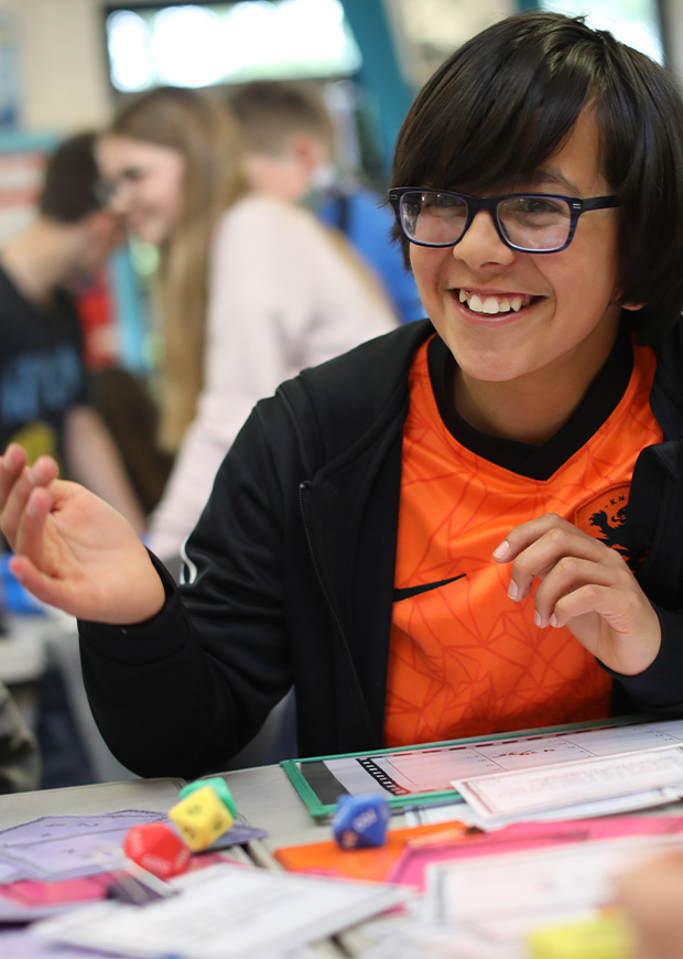 Happy child at desk in classroom 