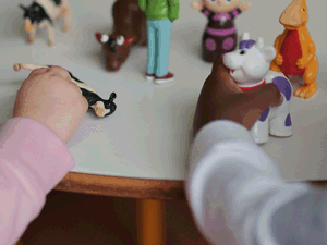 Photograph of children playing with toy figures