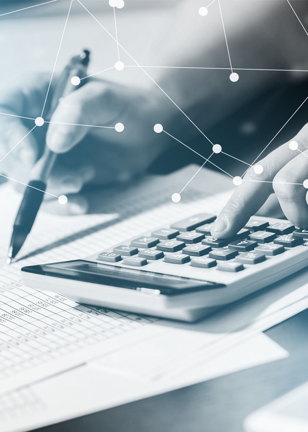 A close up image of a student using a pen and calculator for accounting